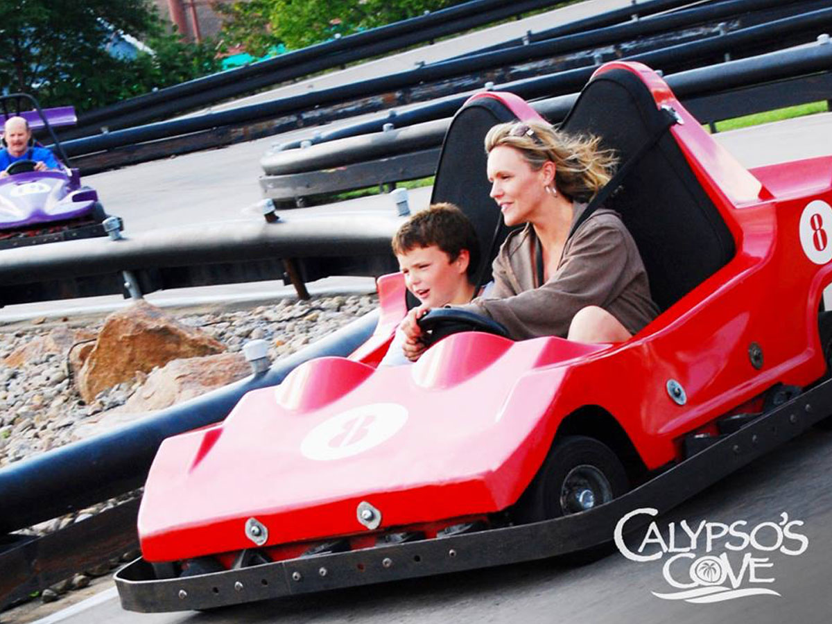 Two guests enjoying a ride on the new go-karts at Calypso's Cove.