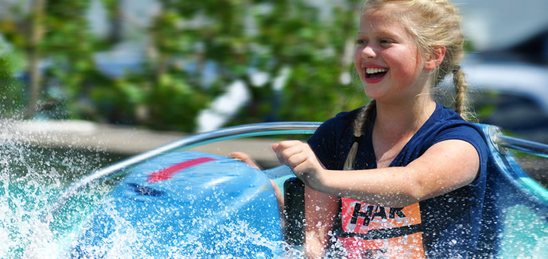 Young girl enjoying a ride on the bumper boats at Calypso's Cove.