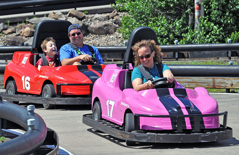 Three guests enjoying a ride on the go-karts at Calypso's Cove.