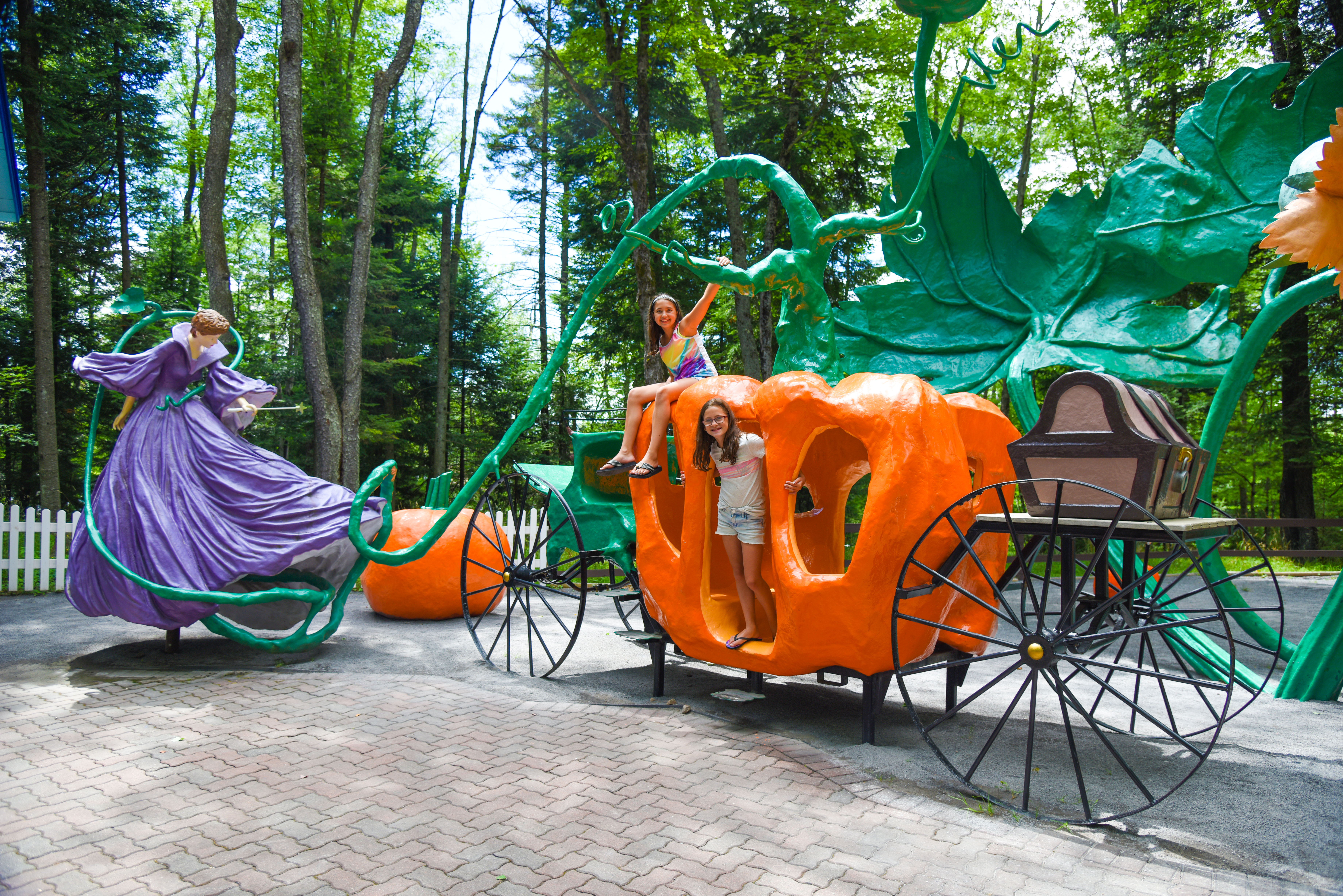 two young girls with one of the attractions on storybook lane