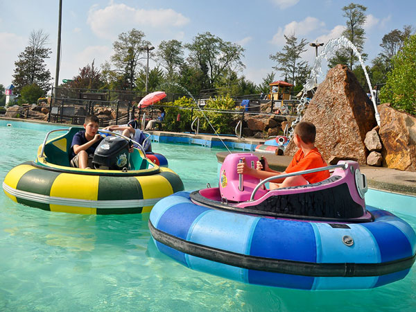 Two boys enjoying a ride on the bumper boats at Calypso's.